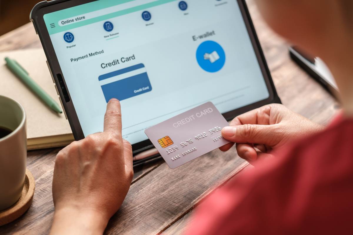 woman at home using credit card for shopping online