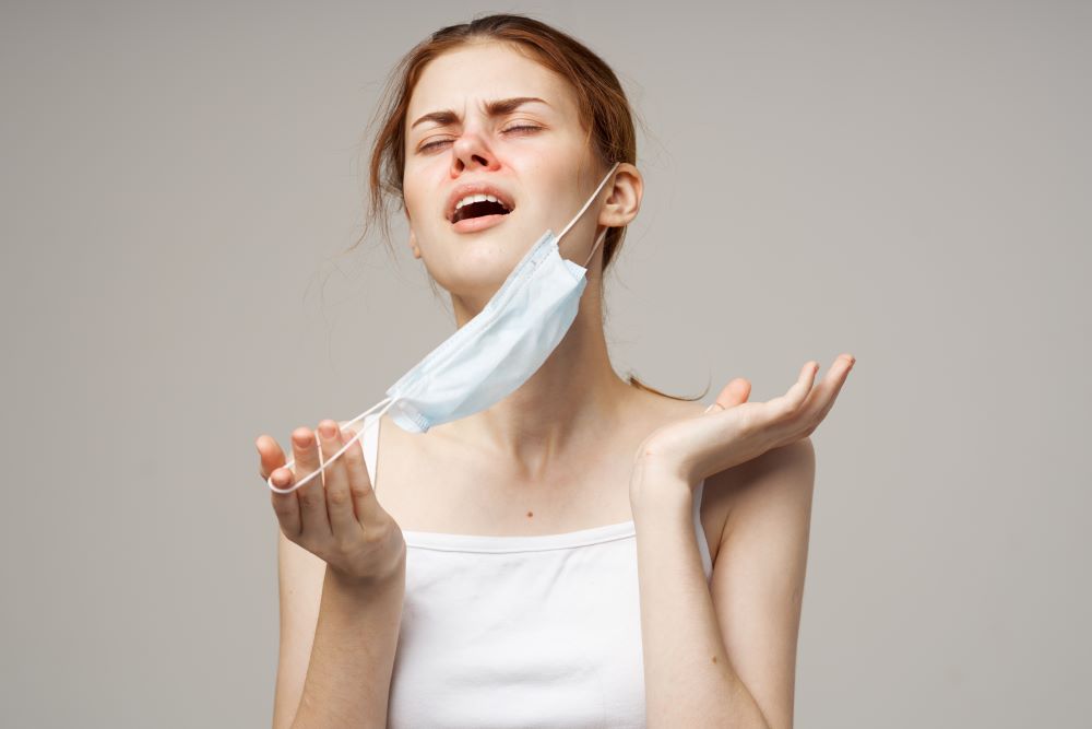 woman-with-medical-mask-runny-nose