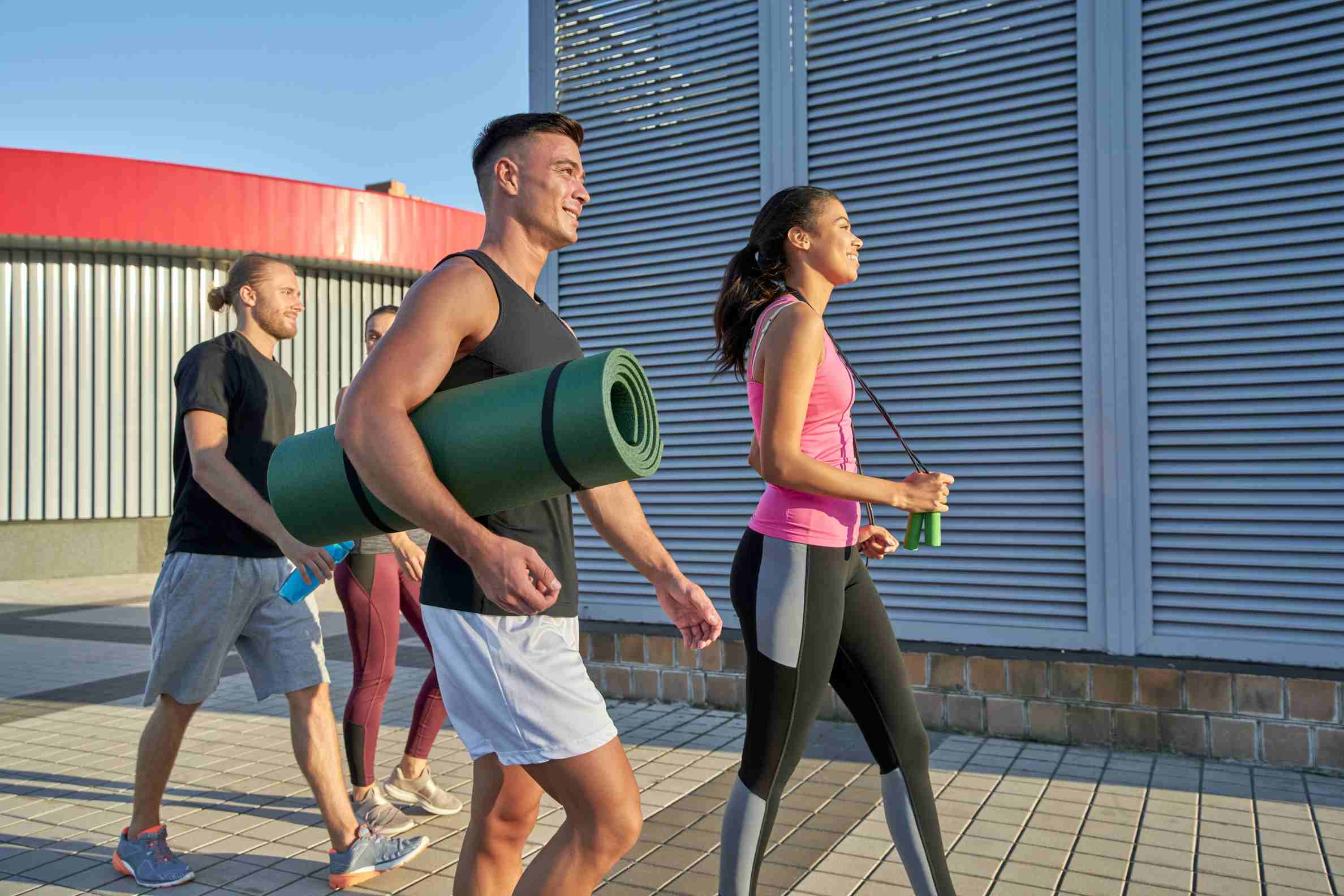 young mixed race sportsmen with workout equipment