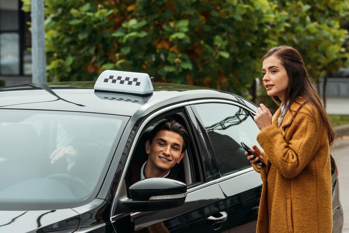 girl talking to taxi driver