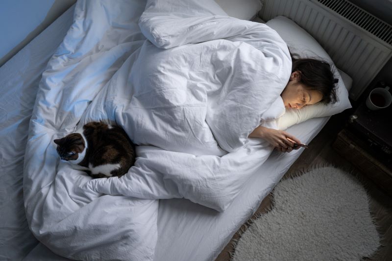 young-woman-using-smartphone-whil-sleeping