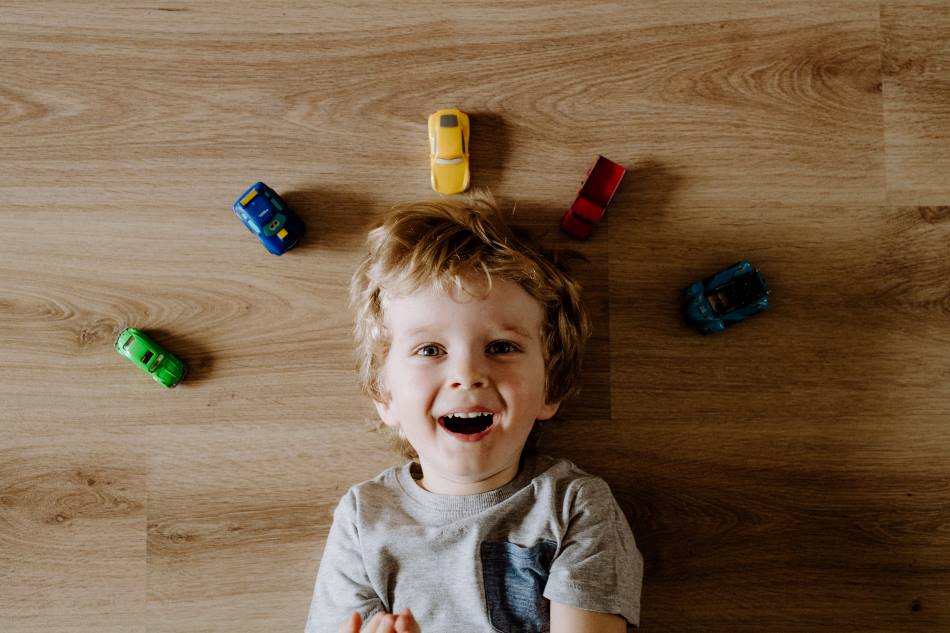 top view of toddler with toy cars