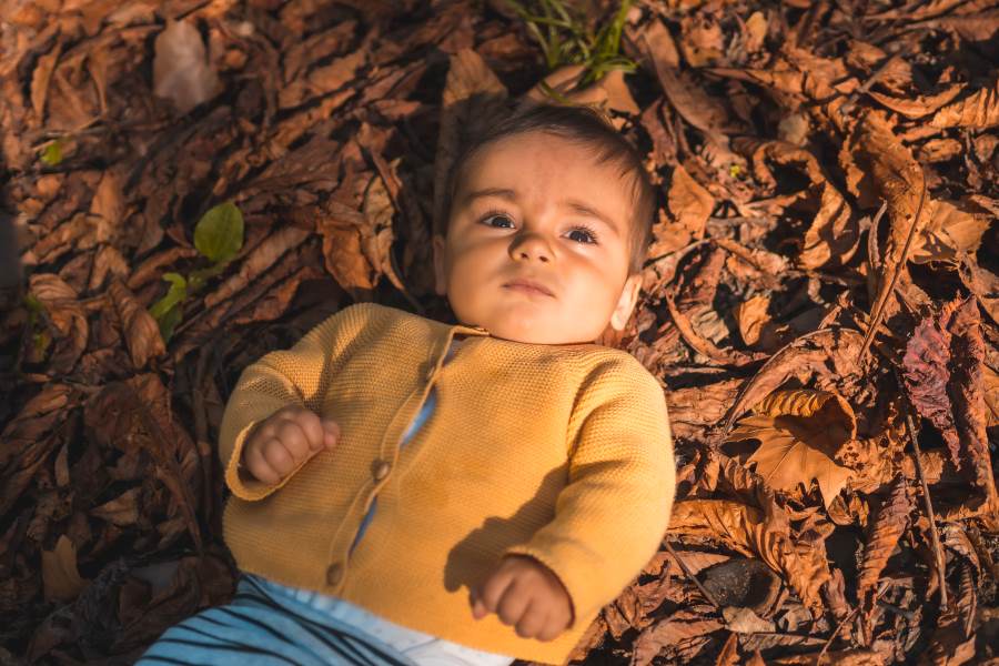 baby boy on autumn leaves