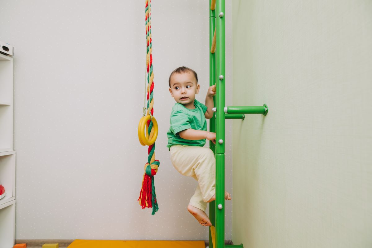 baby climbing a toy ladder