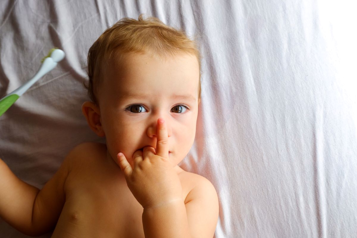 baby touching nose