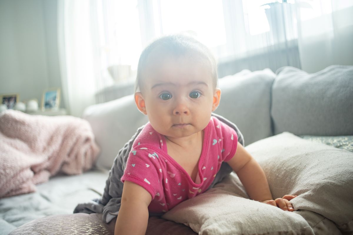 baby posing in bright interior