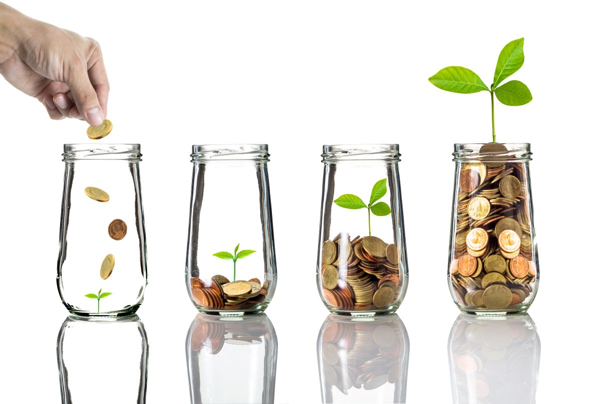 putting gold coins into clear bottle