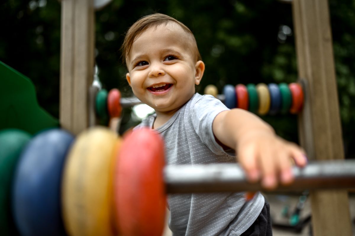 kid plays in a summer park