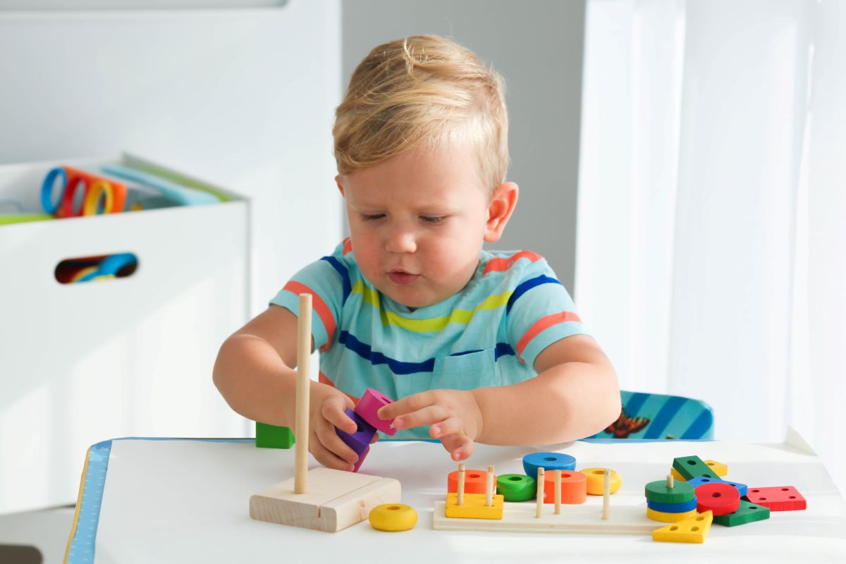 little boy plays with toy