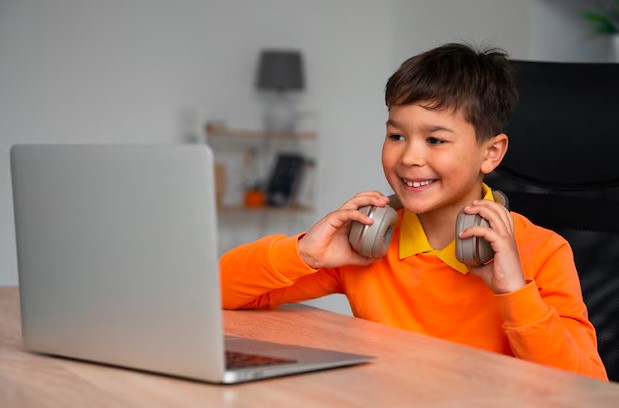 little boy using laptop