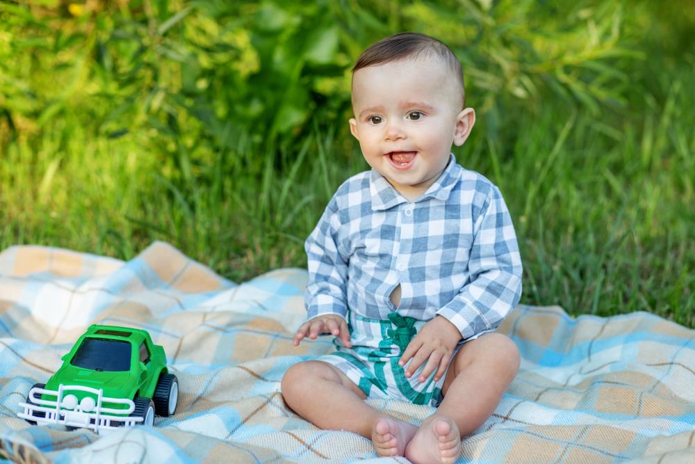 toddler boy playing with toy car