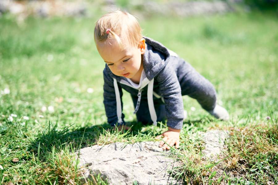 little girl crawling outdoors