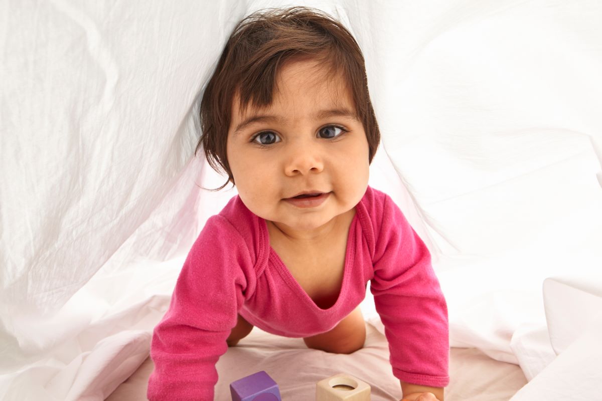 toddler crawling between sheets