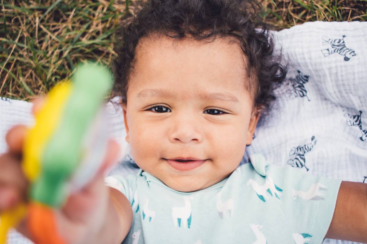 toddler playing with rattle